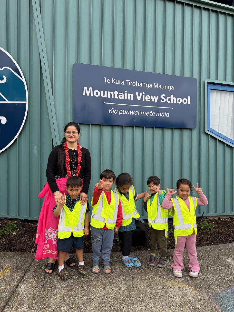 An educator and children visiting the local primary school